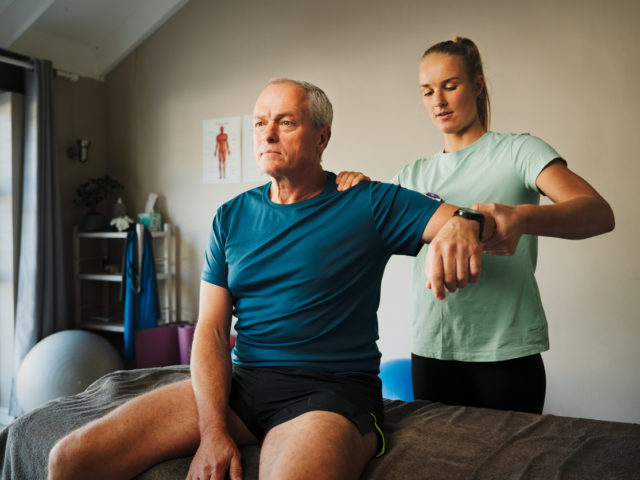 Therapist treating man after orthopedic injuries