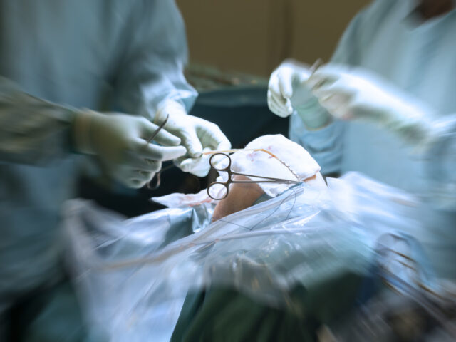 orthopedic surgeon operating knee surgery