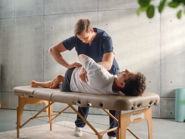 Sportsman Patient Undergoing Physical Therapy in Clinic to Recover from Surgery and Increase Mobility