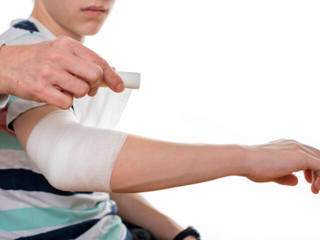 orthopedic doctor bandages her son's orthopedic injury