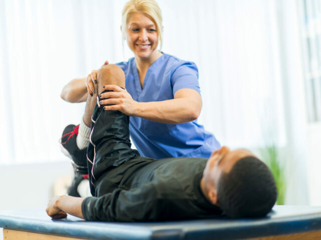 A man is receiving orthopedic treatment from an orthopedic doctor.